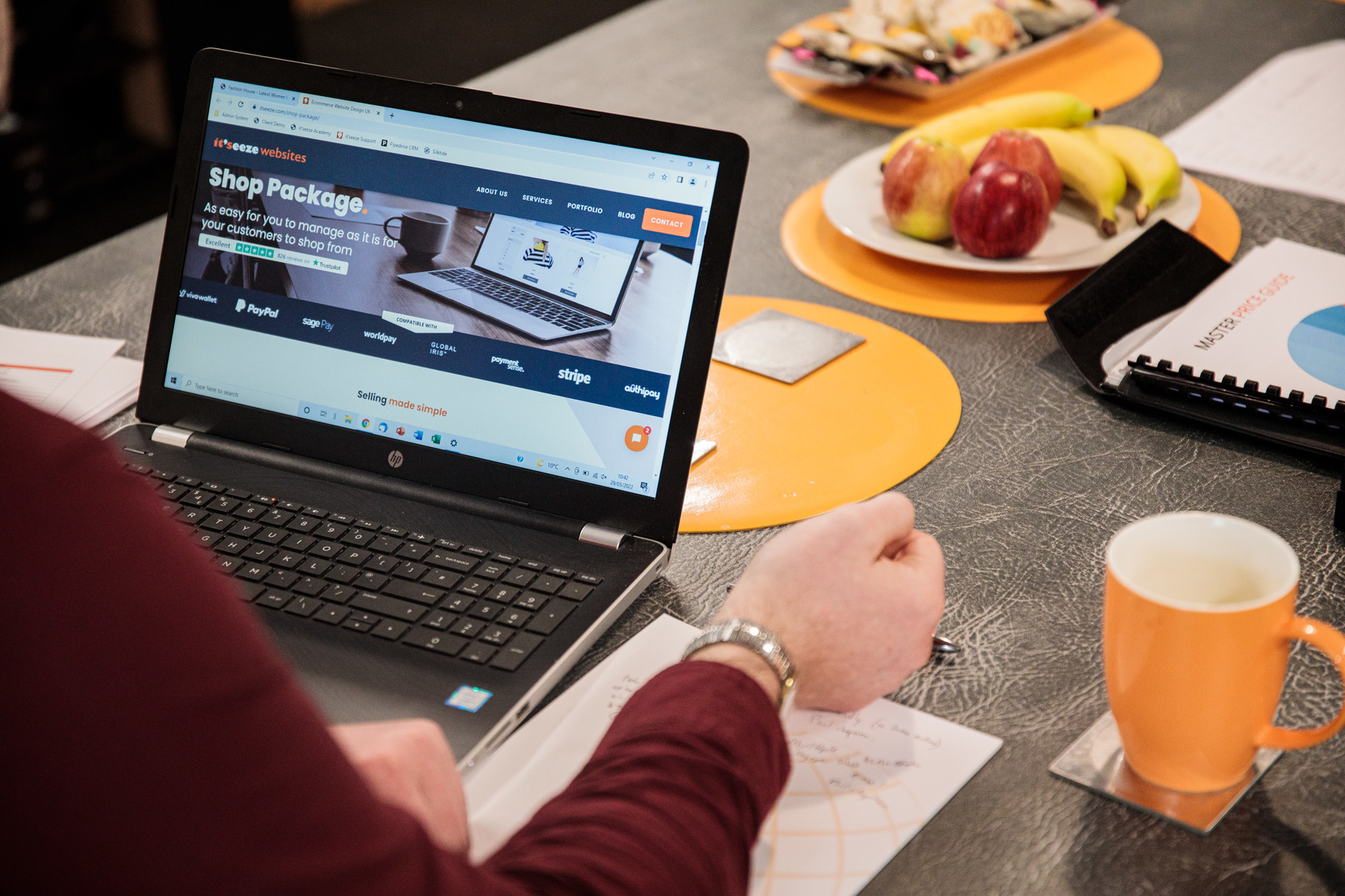 It'seeze web design shown on a laptop with a fruit bowl in the background